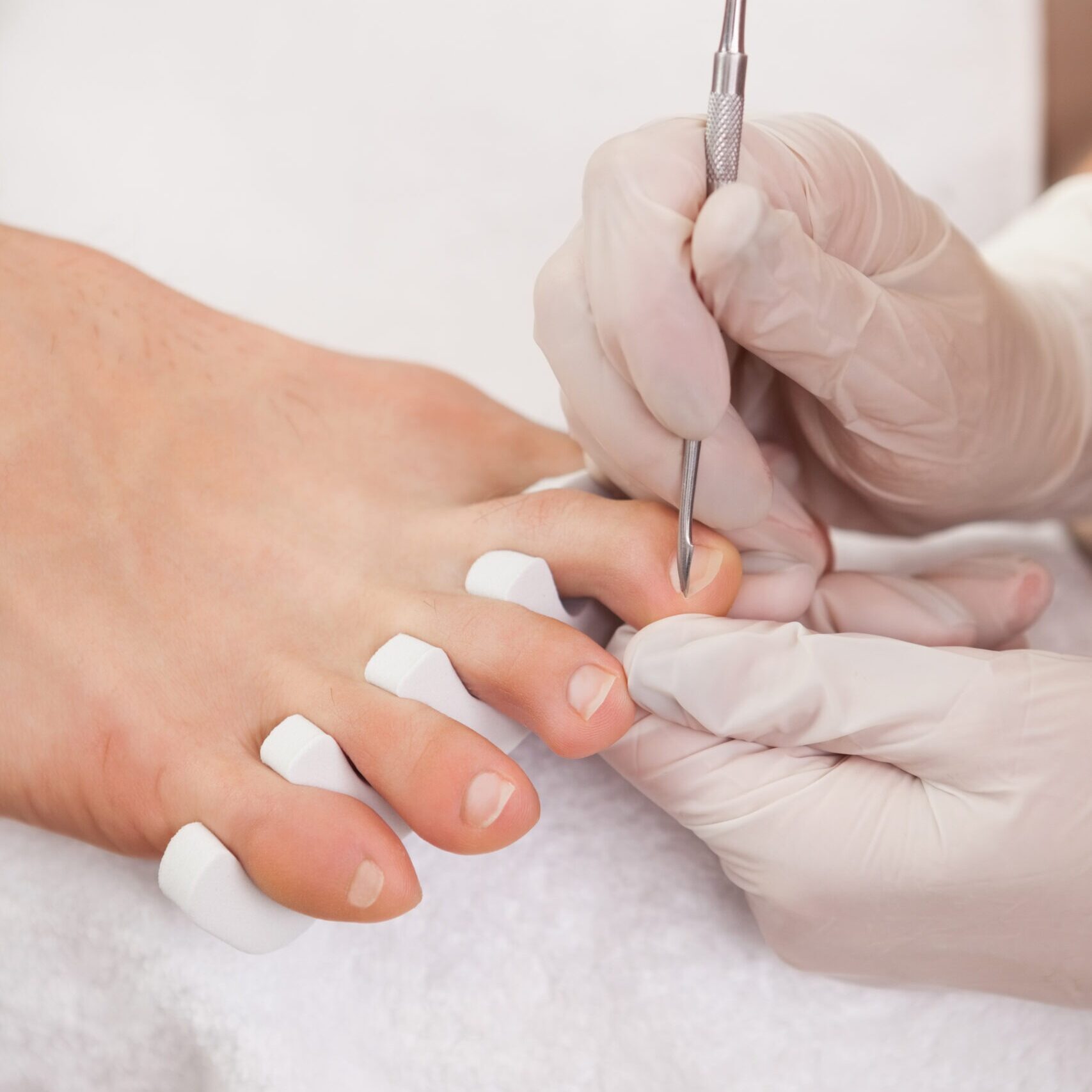 pedicurist working customers feet scaled